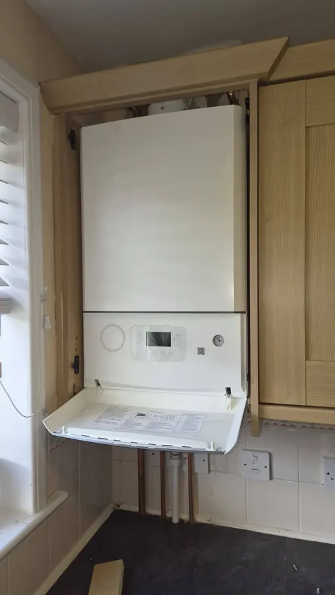 New boiler fitted into a kitchen cupboard